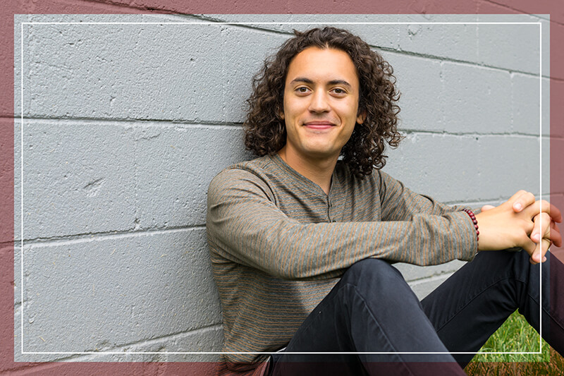 Happy man against a brick wall