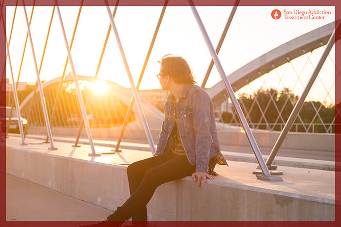 Guy looking out into the sunset presumably happy