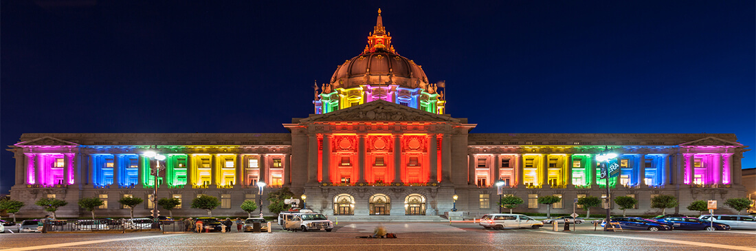san francisco city hall lit up in LGBT support at night