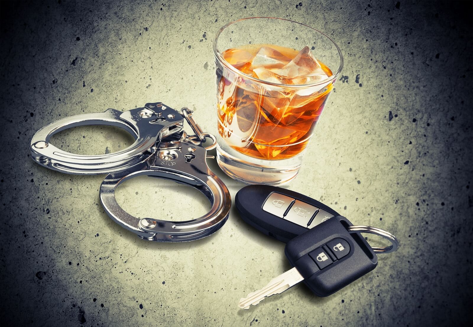 alcohol, keys, and handcuffs on table