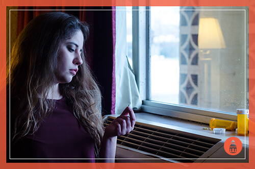 girl staring at a pill containing diclazepam