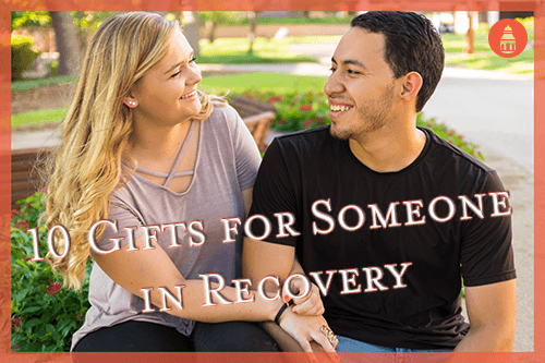 woman hugging man giving him a holiday gift