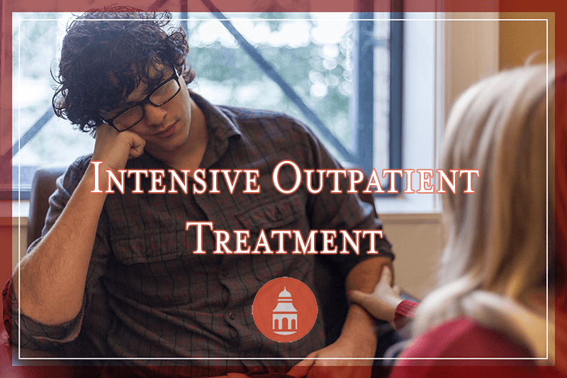 Therapist comforting a sad male patient