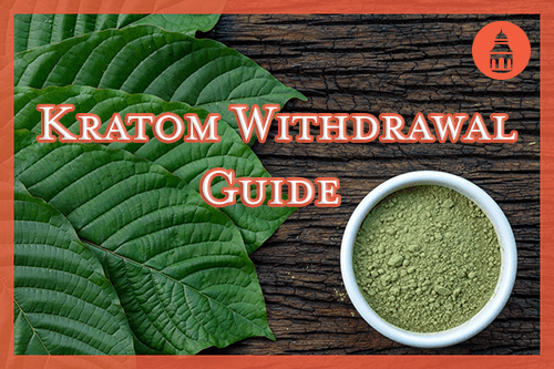 kratom in powder and pill form laying on wooden table