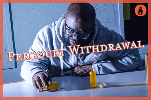 man going through percocet withdrawal while staring at pills