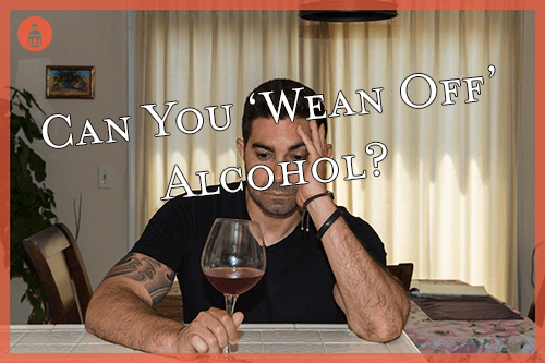 man staring at alcohol attempting to wean off